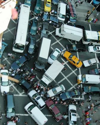 New York City gridlock with pedestrians. Credit.