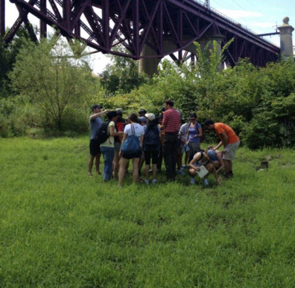 The author leading a field trip in an urban wetland. Photo by Hara Woltz.