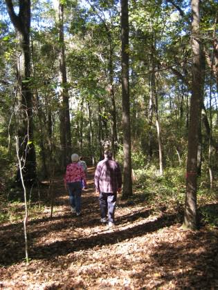 Residents enjoying a stroll through a wooded remnant in a development. Staying on trails is an important action by residents to minimize impacts on local plant and animal communities.  Photo by Mark Hostetler. 