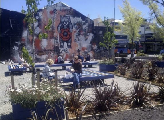 Tess' mural, the stage and seats in use - the park is finished! http://greeningtherubble.org.nz