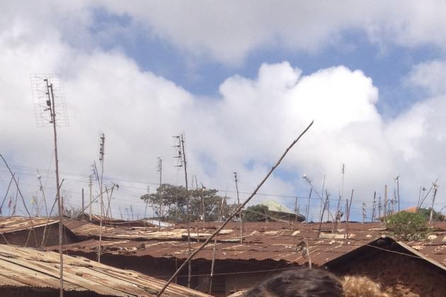 Antennae and power lines above roofs in Kibera, Nairobi. PhotoL Andrew Rudd