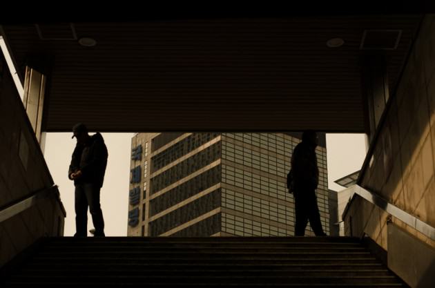 Two men stand at a subway exit in Seoul, South Korea. Photo: Patrick M. Lydon 