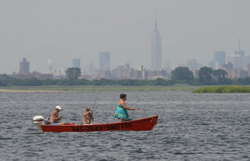 Fishing in Jamaica Bay, with New York skyline. Photo: Don Riepe, American Littoral Society