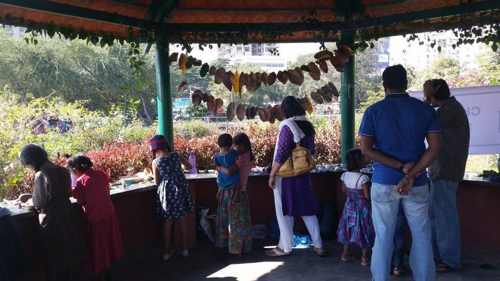 4. Children from wealthy residential areas and local slums working side by side, painting leaves and stones at an urban lake festival in Bangalore