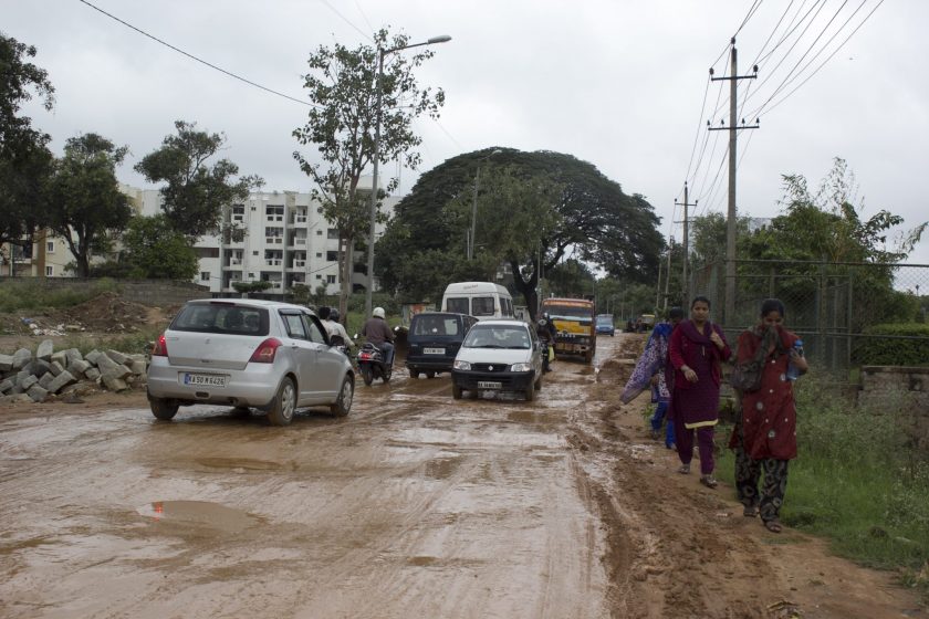 Pedestrians and commuters negotiate their ways to work on a wintry December morning in North Bangalore