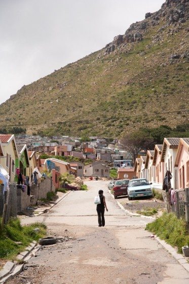 A woman walking along a street in the informal settlement or so-called township of Imizamo Yethu in the Cape Town suburb of Hout Bay.