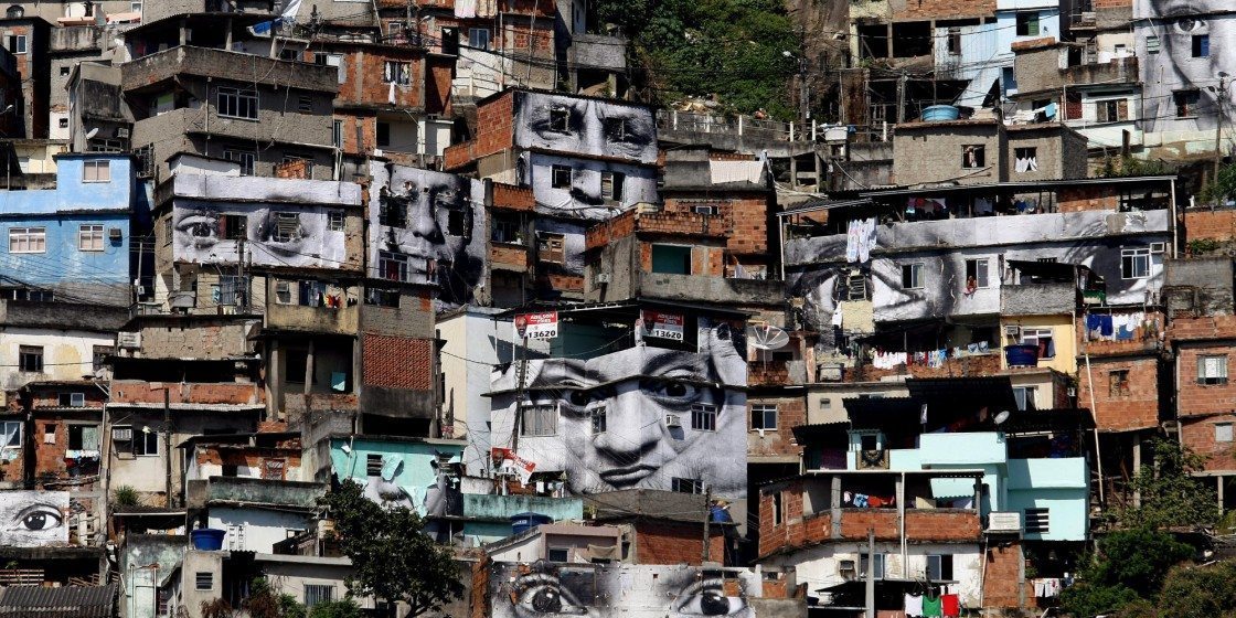 General view of the "Morro da Providencia" favela, one of the most violent of Rio de Janeiro, Brazil, taken on August 20, 2008. The French photographer identified as JR is launching a project called "Women Are Heroes", through which the photographs of women, relatives of the victims of clashes between the police and drug traffickers, were placed in the facades of the houses. This project already took place in Sudan, Sierra Leone, Kenya and Liberia, and will be taken to India, Cambodia, Laos and Morocco after Brazil. AFP PHOTO/VANDERLEI ALMEIDA (Photo credit should read VANDERLEI ALMEIDA/AFP/Getty Images)