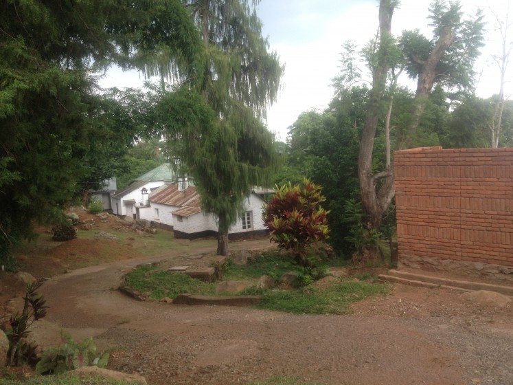 typical colonial residence with a brick wall surrounding the neighbours plot