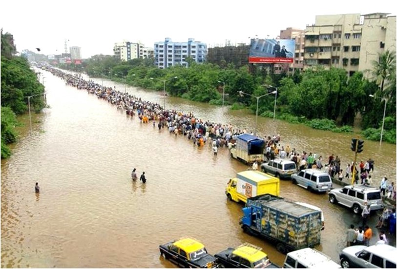 A flooded street with cars and people