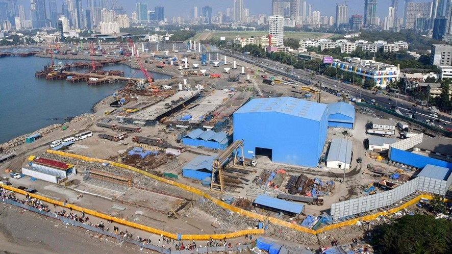 A picture of a coastal landfill with several buildings