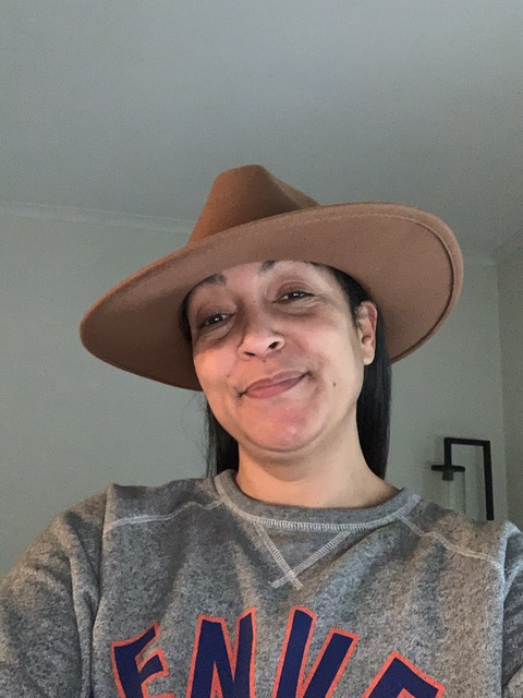 A person in a hat, smiling