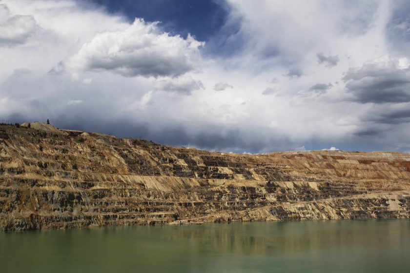 A picture of a rocky bluff on the edge of a water source