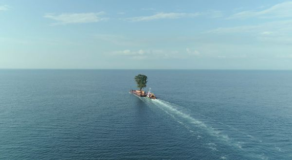 A picture of a boat in the middle of the ocean