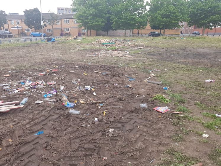 A picture of a field of dug up dirt and trash