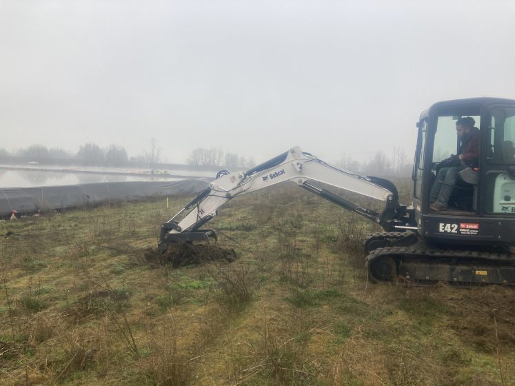 A picture of a backhoe in a field