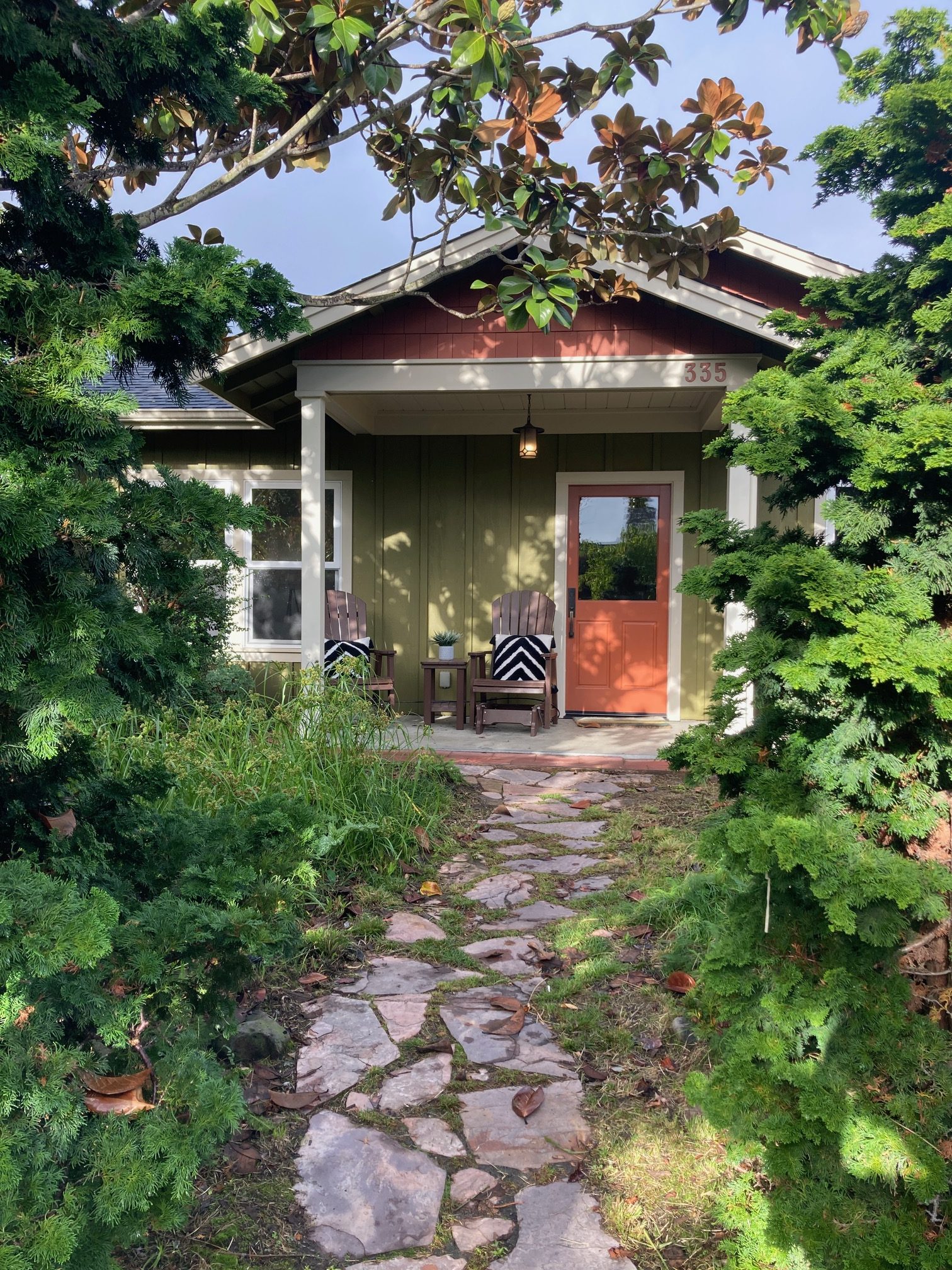 A picture of a walkway leading up to a small house