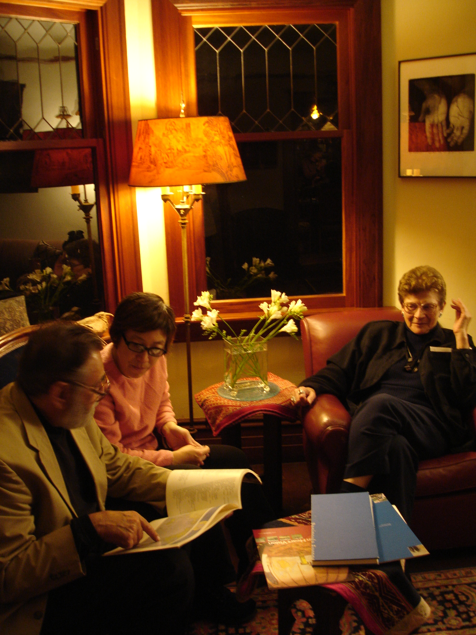 A picture of three people sitting in a living room