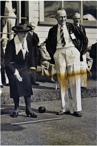 A black and white picture of a two people standing in business wear