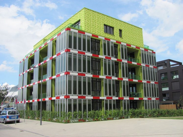 A picture of a glass and green building