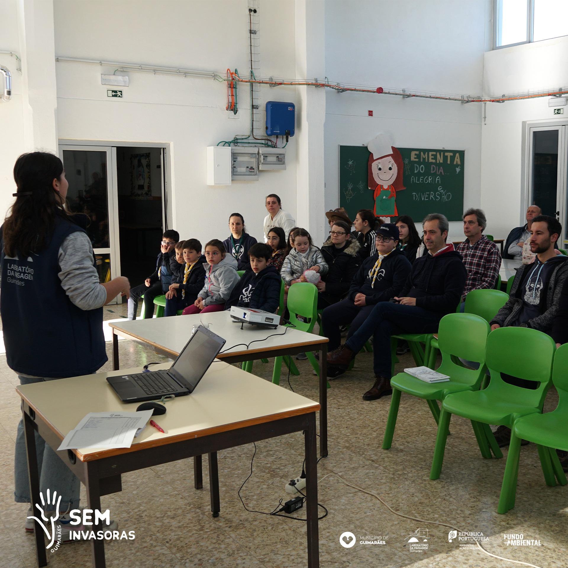 A picture of a person talking to a classroom full of kids