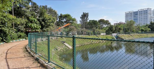 A picture of a fenced walkways along a lakeside