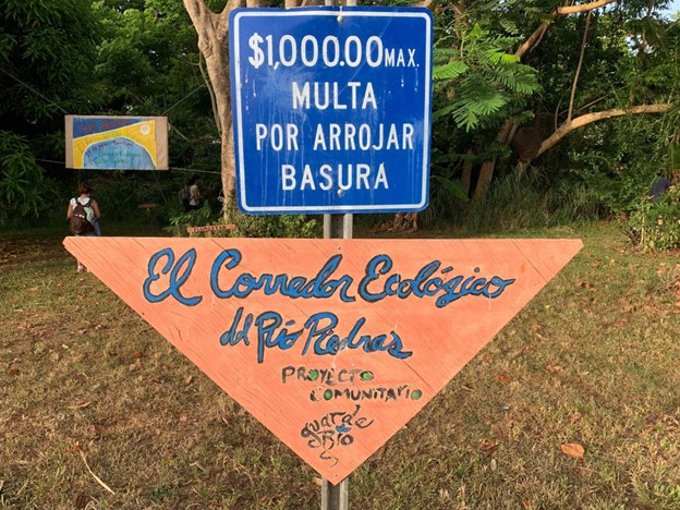 An orange triangle sign with writing on it