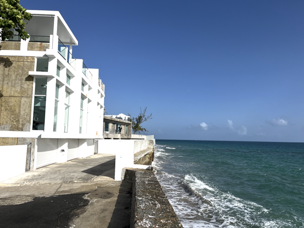 A white building next to the ocean