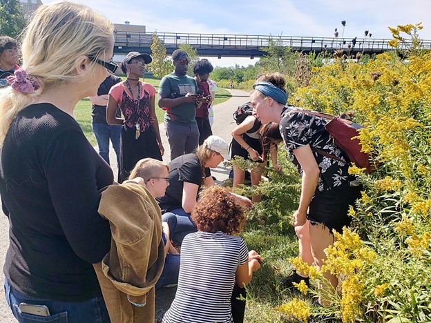 A group of people standing around plants