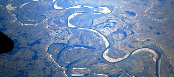 An aerial view of an oxbow river with many natural twists and turns