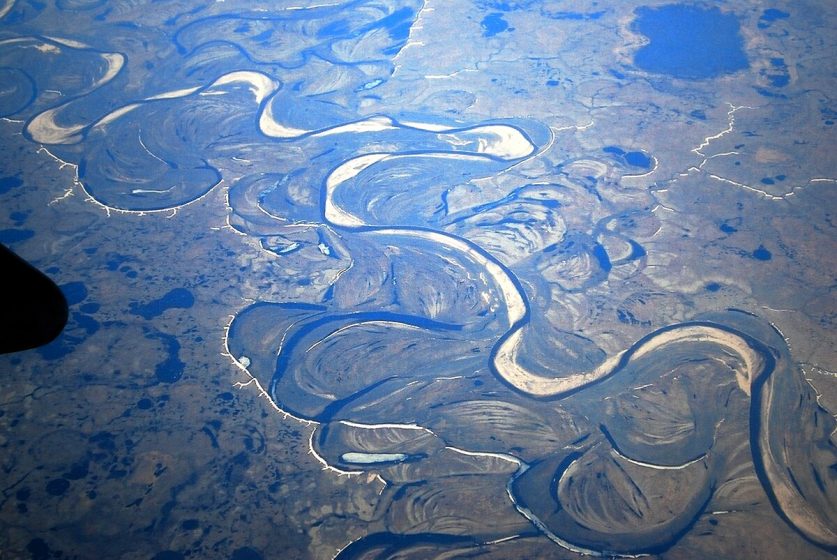 An aerial view of an oxbow river with many natural twists and turns