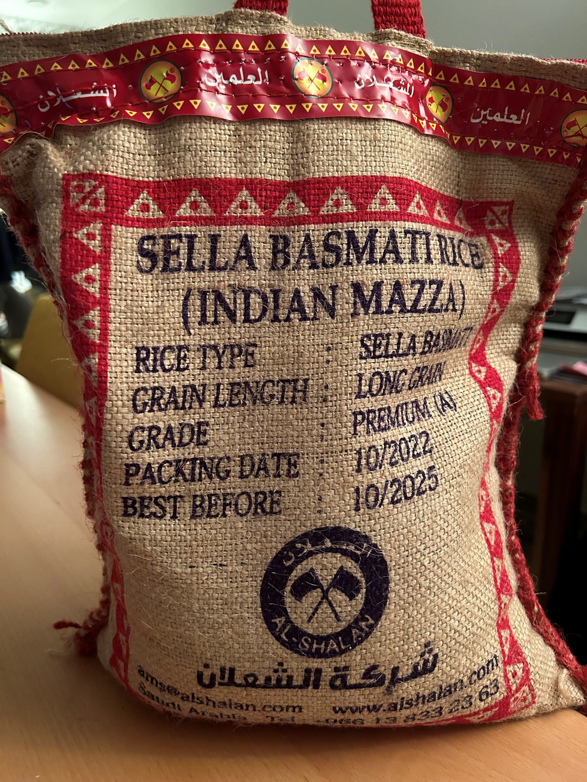 A burlap sack with a red and black text