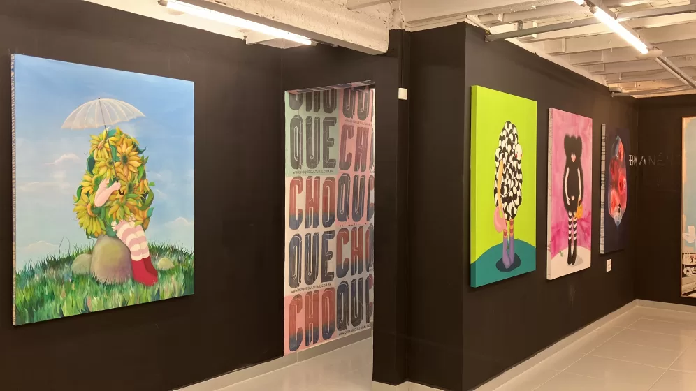 A gallery wall of several colorful paintings