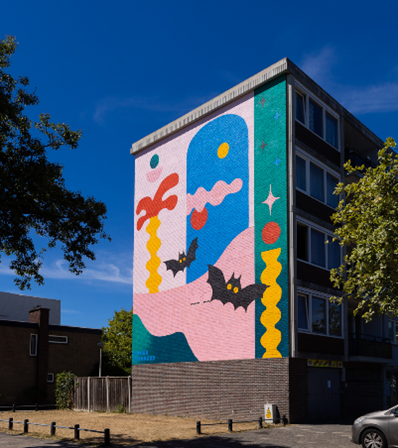 A picture of a colorful mural in a park during night