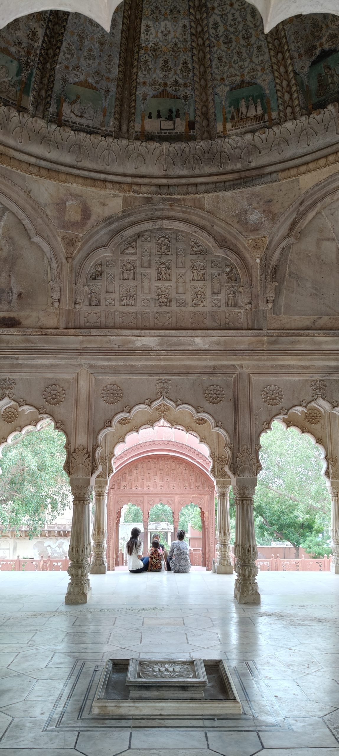 A highly detailed carved stone dome in a garden