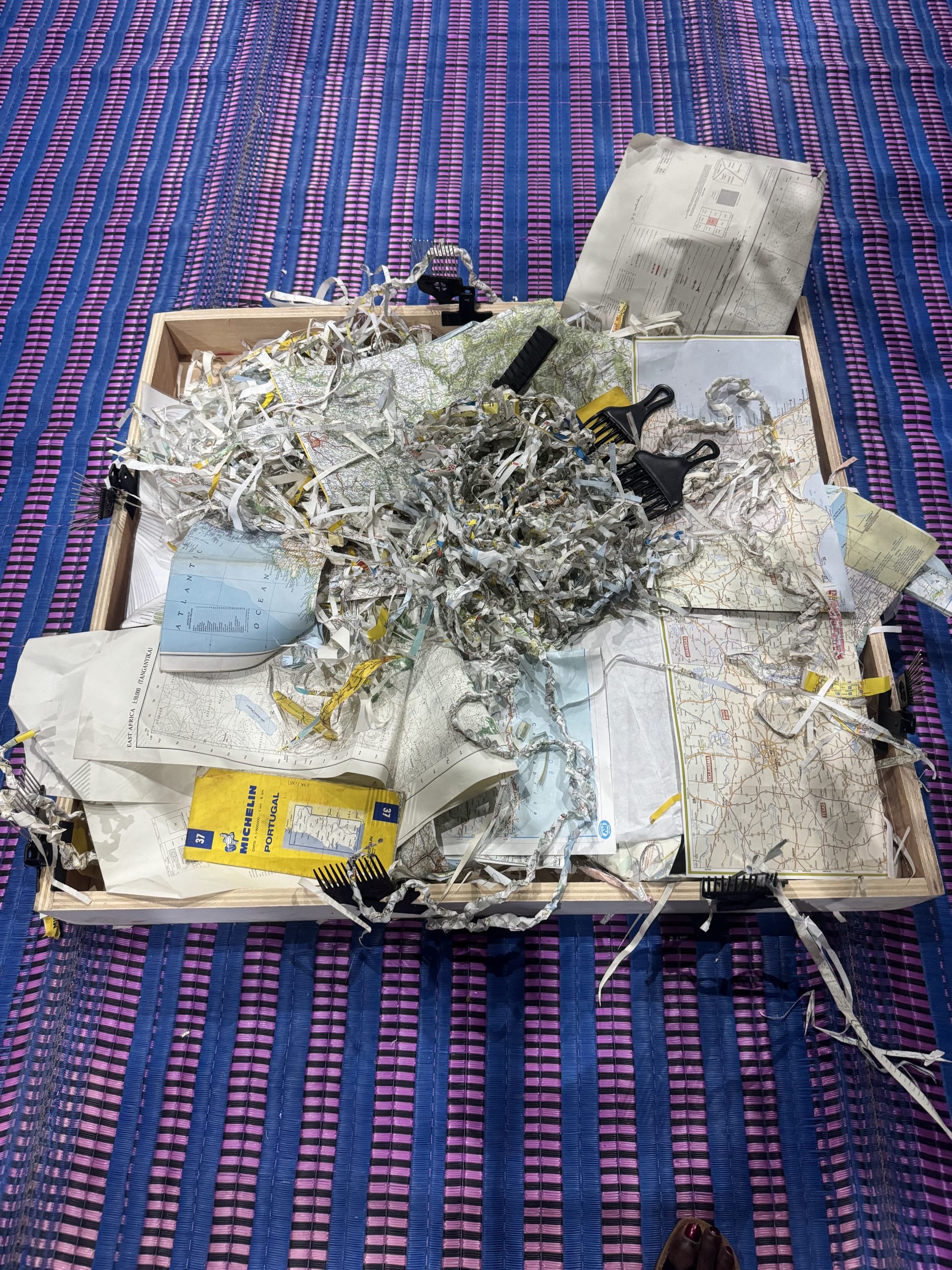 A box with shredded paper on a blue and purple blanket