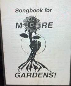 A sign with a flower and text