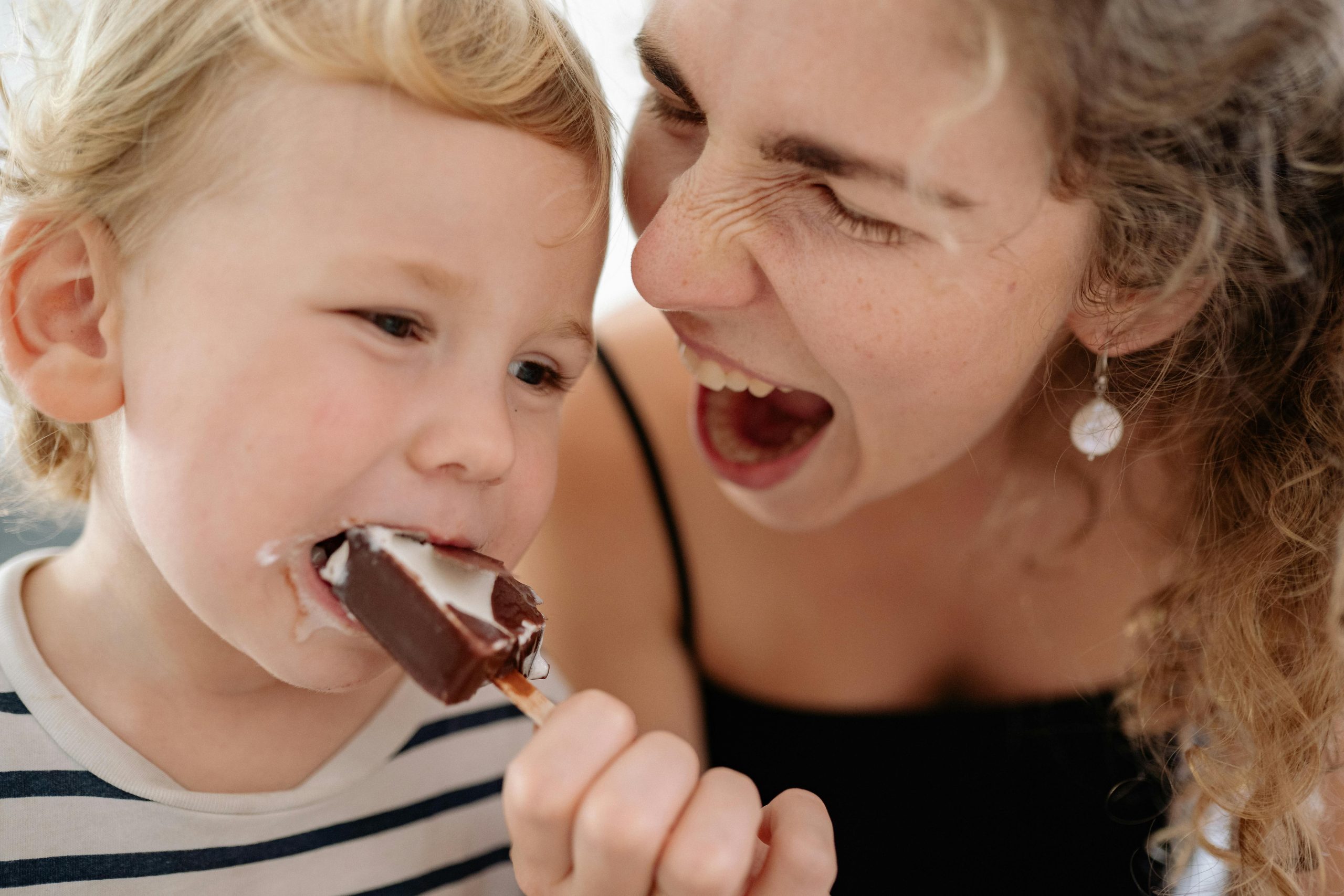 A Woman Feeding Her Son Ice Cream