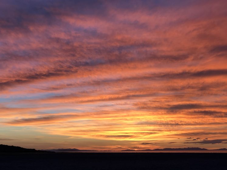 A vibrant pink, orange, and yellow sunset