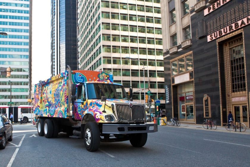 A truck with a colorful paint job on a street