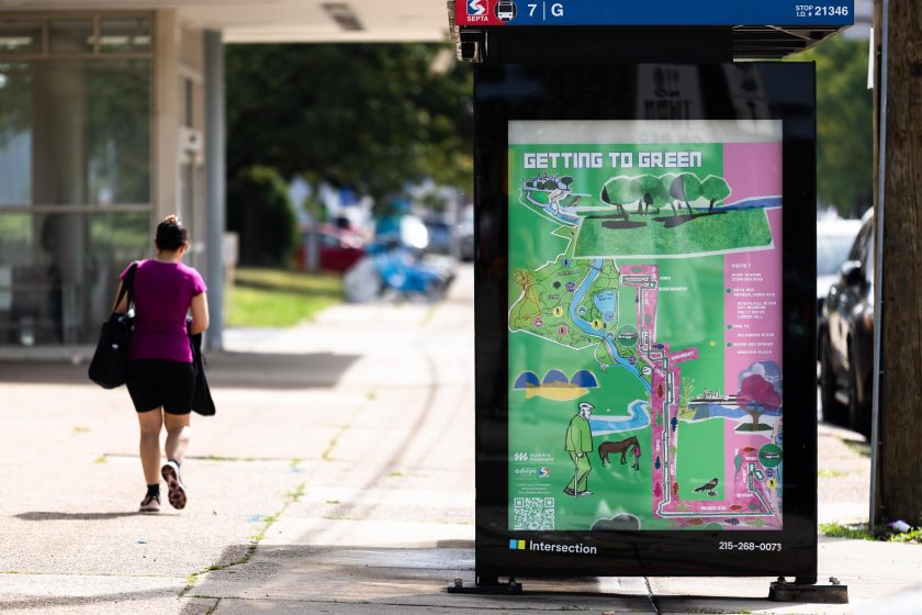 A sidewalk with a map posted on a standing sign