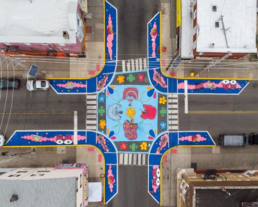 A crosswalk with colorful painted flowers and instruments