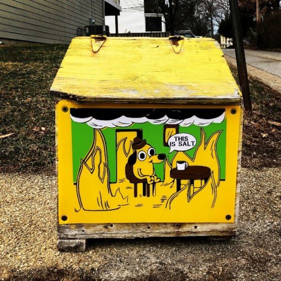 A yellow salt box with an illustration of a dog on a chair drinking coffee while everything around it is on fire