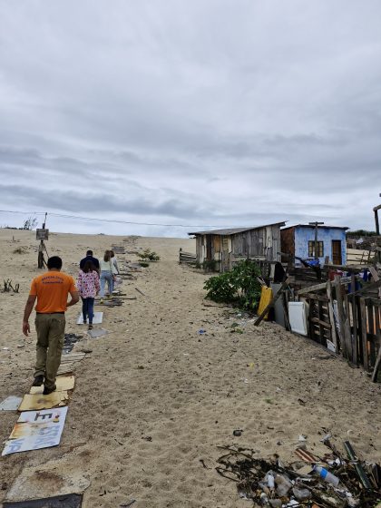 A group of people walking on a beach