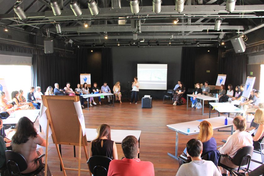 A group of people in a room looking at a slideshow