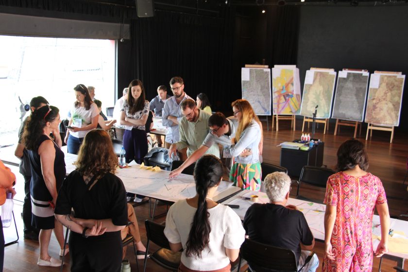 A group of people in a room working on a project together