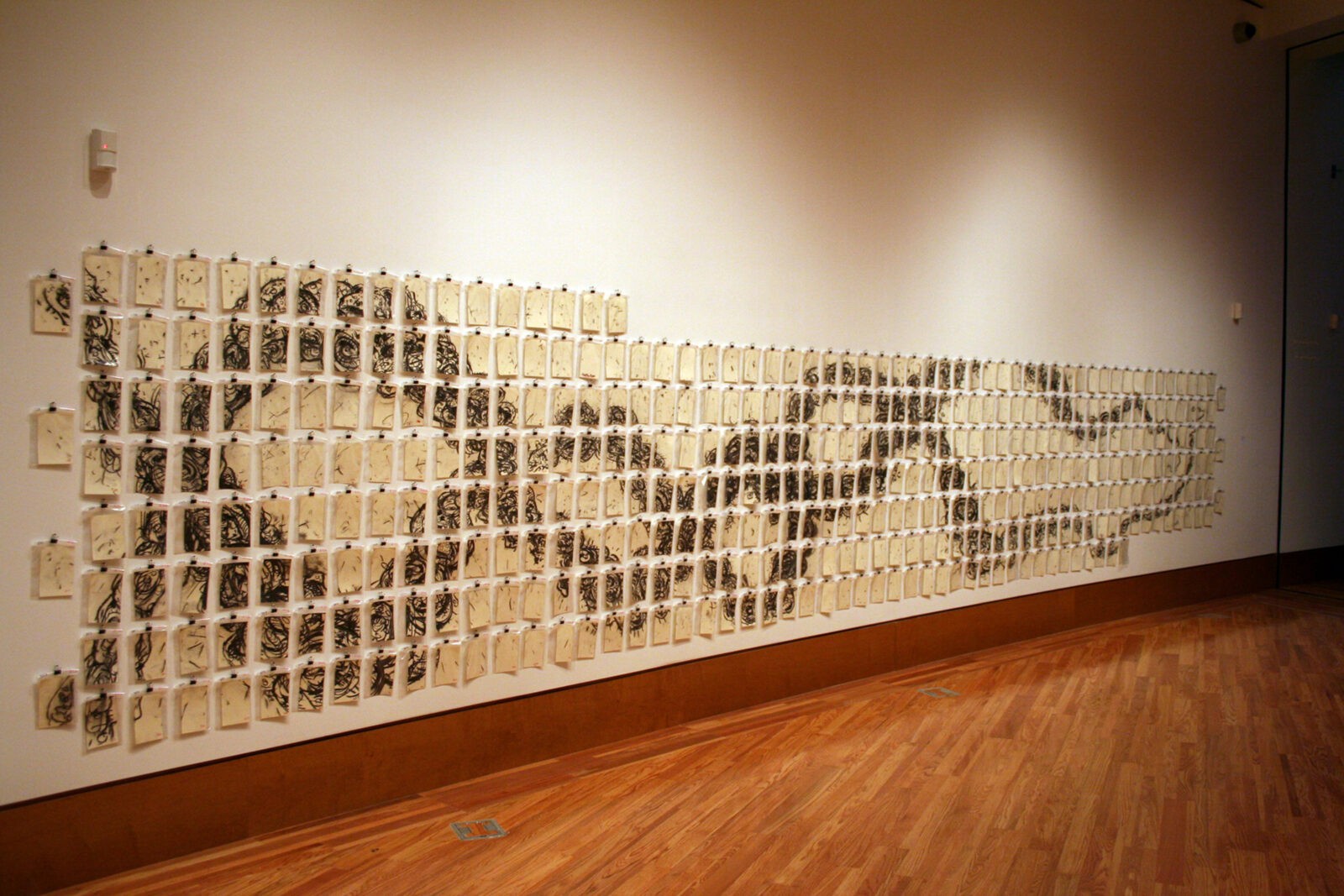 A wall with many pieces of paper depicting a DNA spiral like twist