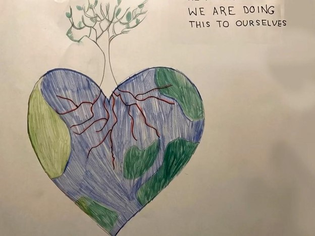 A drawing of Earth in the shape of a heart with a tree coming out the top