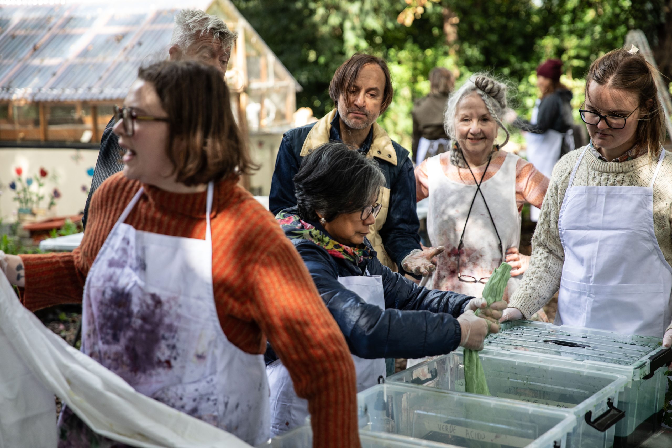 Several people at dying stations, mixing dyes