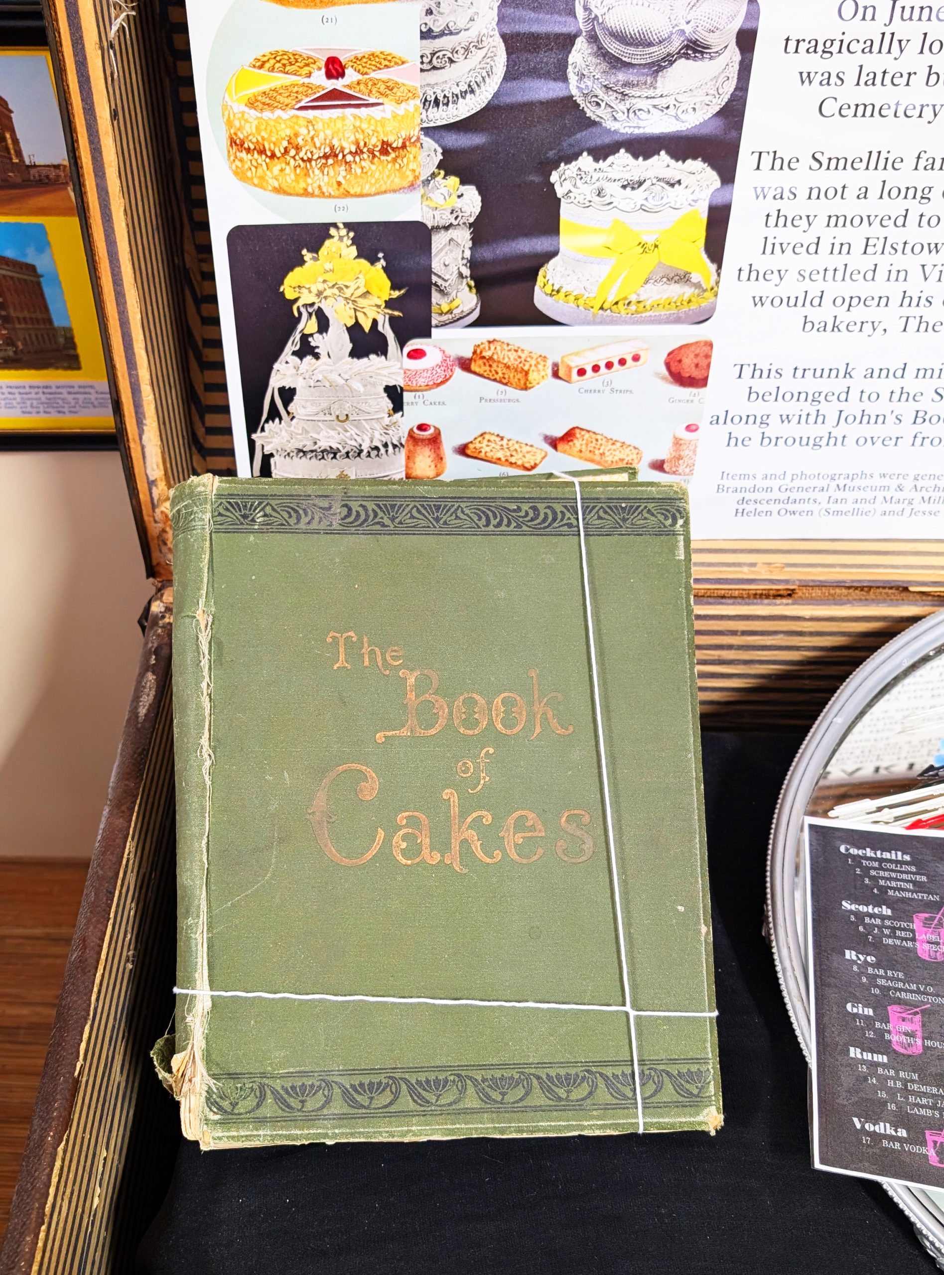 A green book on display "The Book of Cakes"