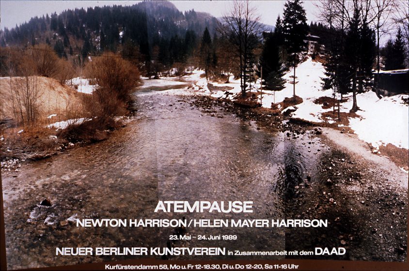 Photo of a partially frozen river flowing through a snowy, forested landscape with hills in the background. Text overlay promotes an art exhibition titled "Atempause" featuring Newton Harrison, Helen Mayer Harrison, held May 23-24, 1989, at Neuer Berliner Kunstverein with DAAD collaboration.